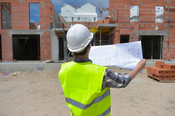 Construction manager checking building project on site