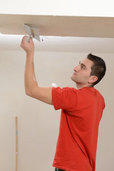Renovation-Construction: Man installing plasterboard