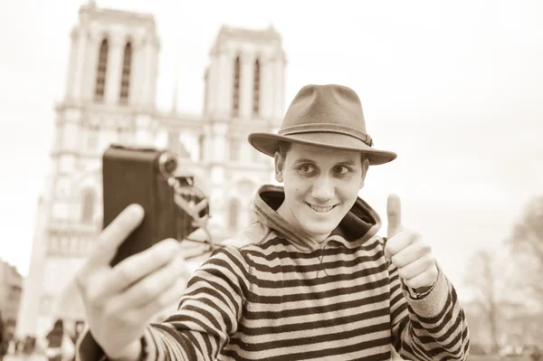 France, Paris, young man taking photograph, Cathedral Notre-Dame