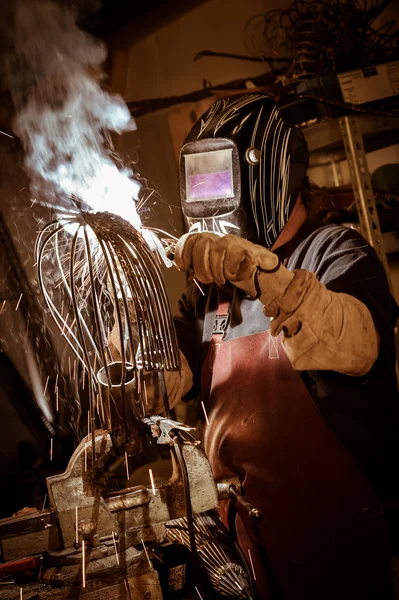 Metal worker standing in workshop