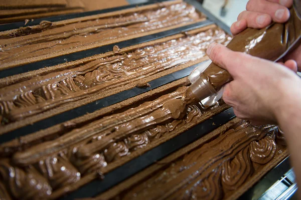 Pastry in his workshop preparing Chocolate Yule logs