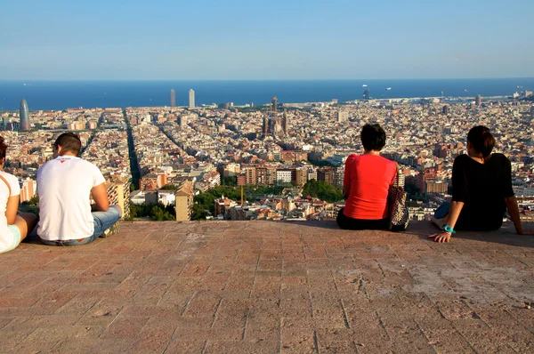 Young people are watching the skyline of Barcelona