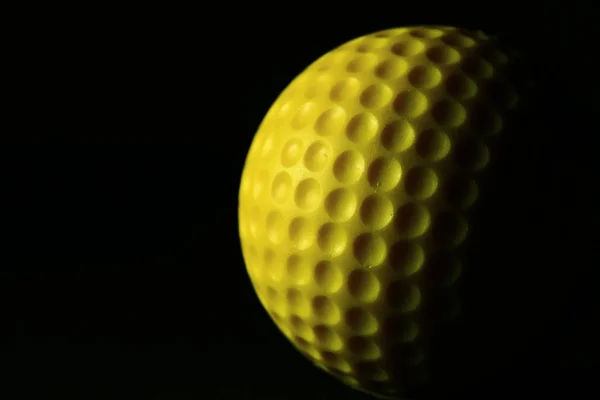 Closeup of yellow golf ball.