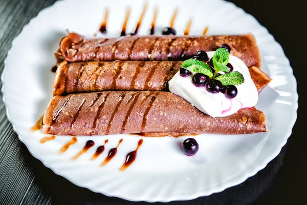 Tiramisu Pancakes with cream and berries, sweet, watering chocolate