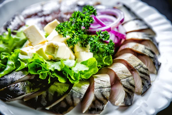Chopped roasted and pickled herring with onions cheese and herbs