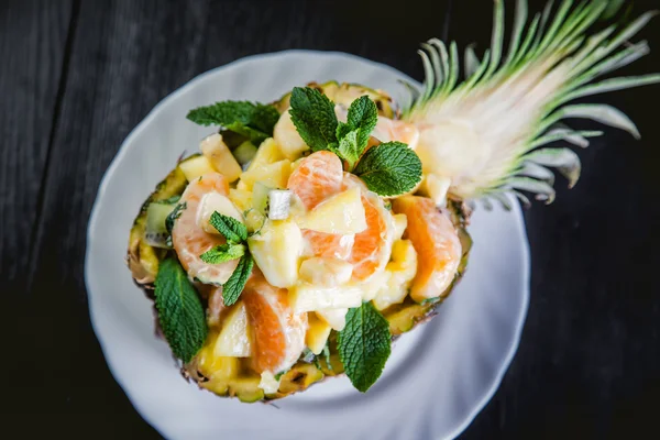 Dessert fruktov?y salad in a plate of pineapple