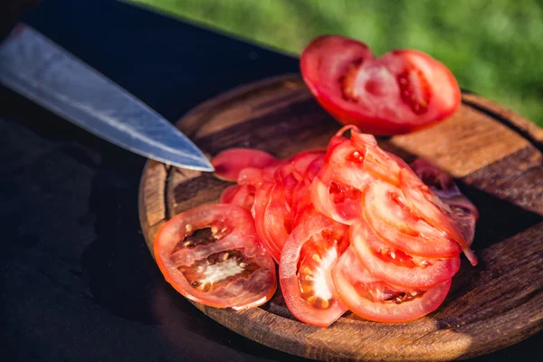 Sliced tomatoes on a wooden board
