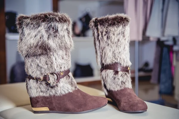 Fur winter boots are on display in the store, women\'s shoes