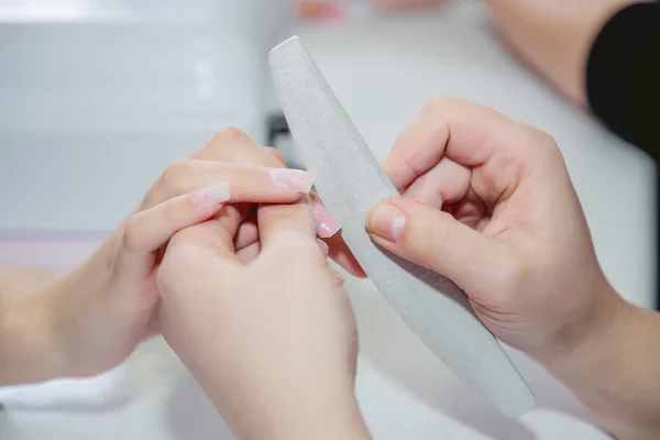Polishing nails in a beauty salon