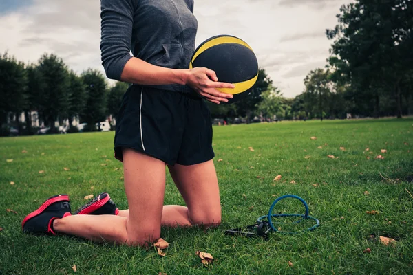 Woman with medicine ball and resistance band