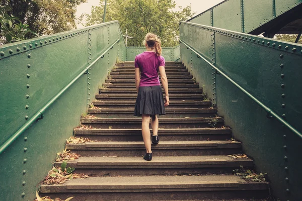 Young woman walking up stairs