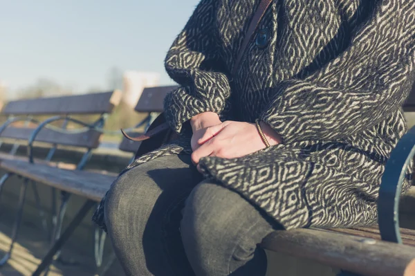 Woman relaxing by water in a park