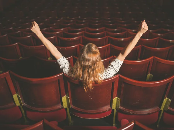 Excited woman in auditorium