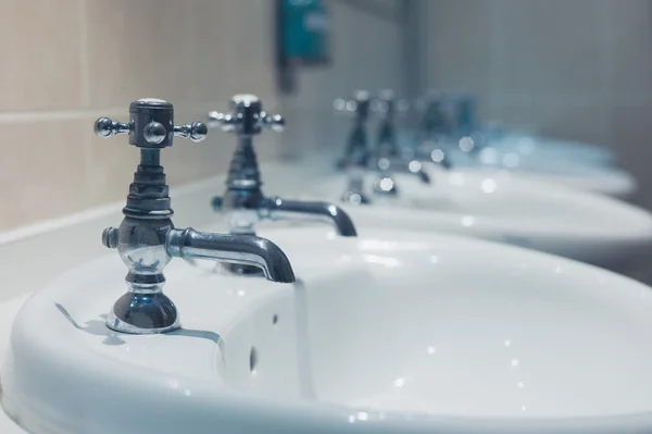 Row of wash basins in a bathroom