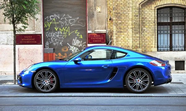 Deep blue Porsche sport car in the street of Budapest