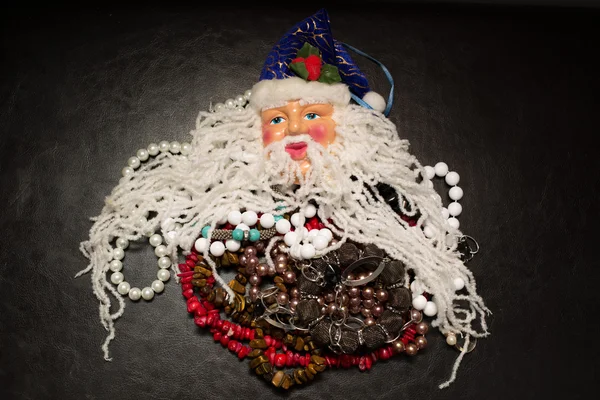 Decorative Santa Claus with various jewelry gifts under his beard