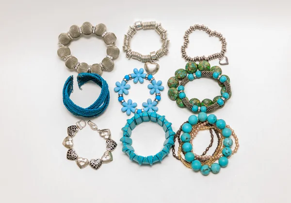Various fashionable pretty stylish bracelets isolated on grey background