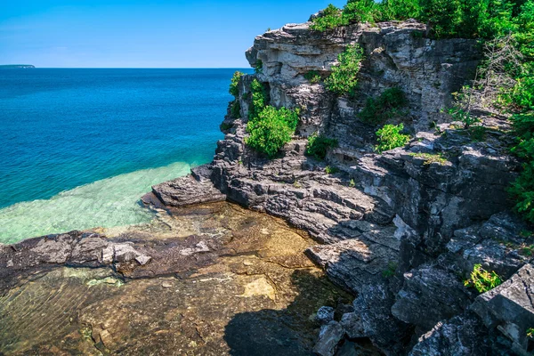 Cliffs rocks above great Cyprus lake tranquil turquoise water at beautiful gorgeous Bruce Peninsula, Ontario