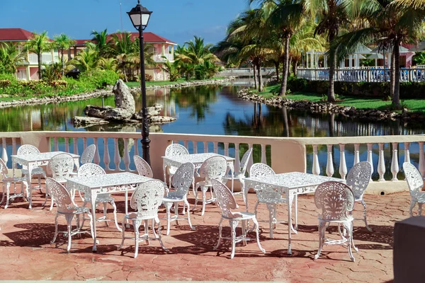 Amazing , gorgeous inviting view of Memories resort landscape, outdoor cafe, patio with metal vintage retro classic chairs at early morning on sunny day