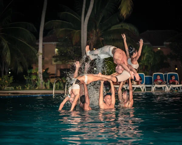 Professional dancers performing  water show in outdoor swimming pool