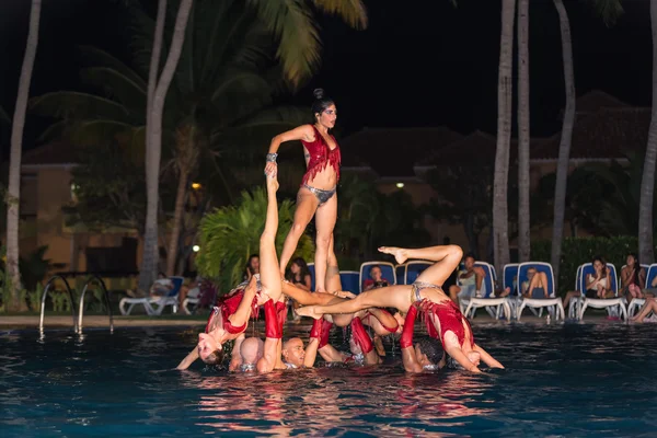 Passionate professional Cuban dancers at night swimming pool
