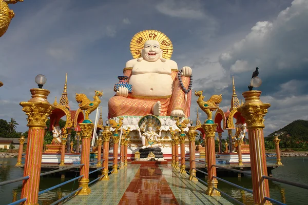 A large statue of the laughing Buddha. Temple Wat Plai Laem. Koh Samui, Thailand