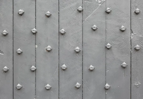 Close up image of old grey painted wooden door