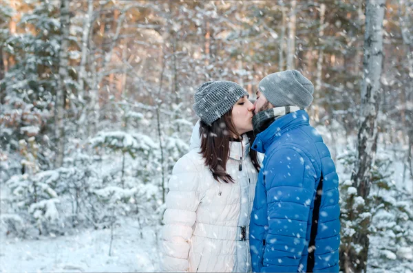 Happy couple in love in winter forest