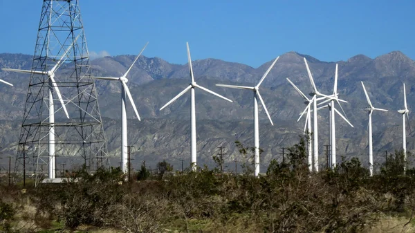 Series of wind mills against mountains