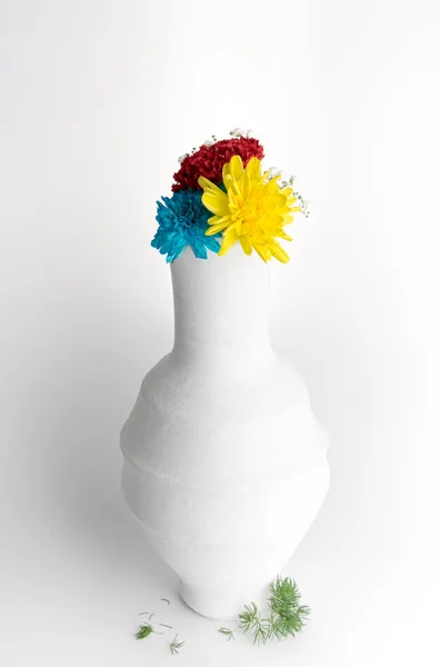 White pottery vase with flowers on white background