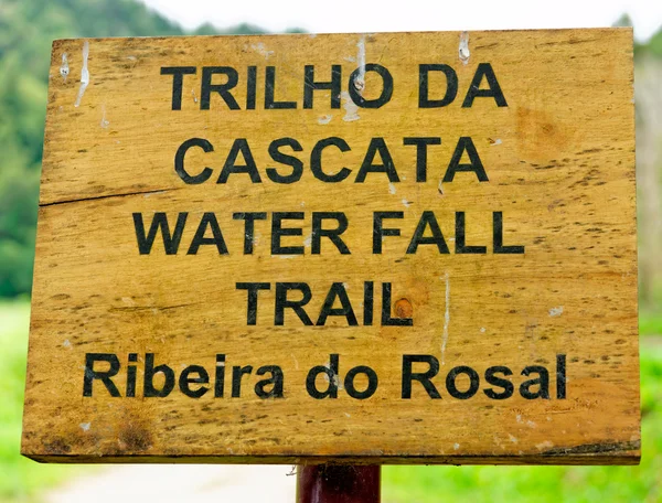 Wooden plaque in the direction of the waterfall
