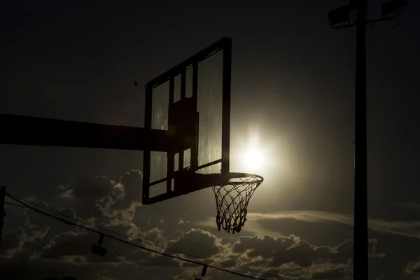 Silhouette of a basketball hoop.