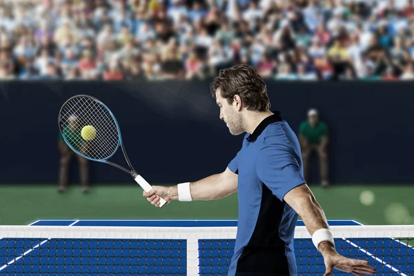 Tennis player with a blue shirt.