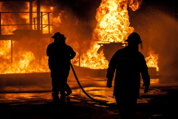 Firefighters fighting blazing fire