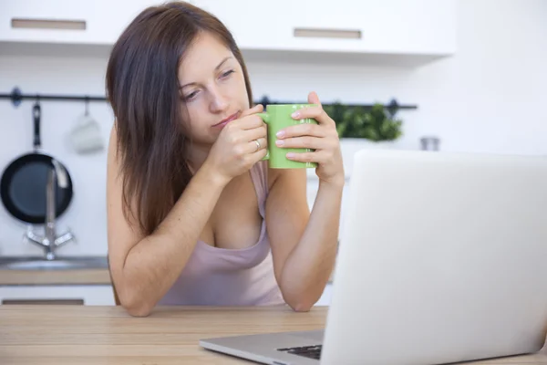 Woman drink tea at the workplace at home