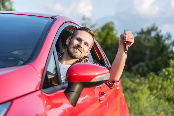 Man Sitting In A Car Showing New Car Key.
