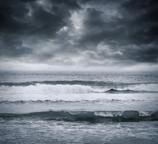 Dark stormy sky and sea waves.