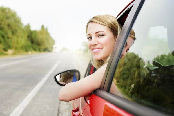 Woman in red car.