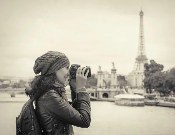 Girl taken pictures Eiffel Tower.