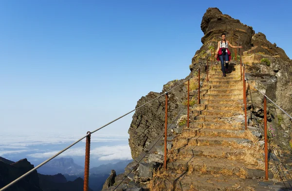 Young woman on the winding mountain trekking path at Pico do Arieiro
