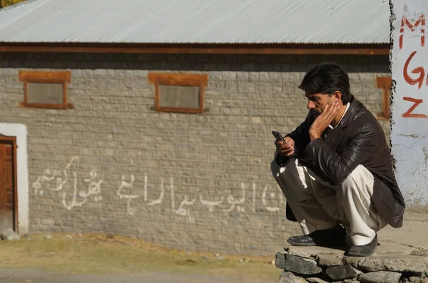 Pakistani man looking at his cellphone, Pakistan