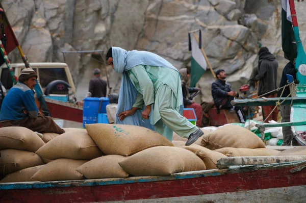 Pakistani man working at the boat,Attabad Lake, Pakistan