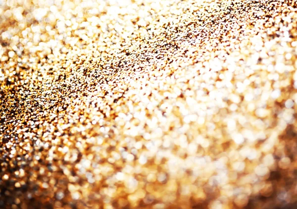 Glitter background with blinking lights and golden texture.