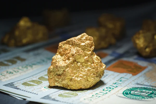 big gold nugget and dollar bills