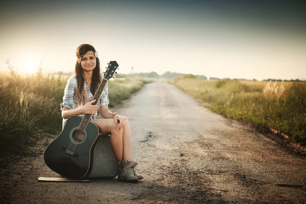 Traveler hippie girl with guitar