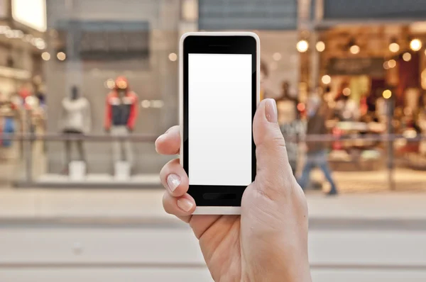 Smartphone with empty screen in woman hand in shopping center