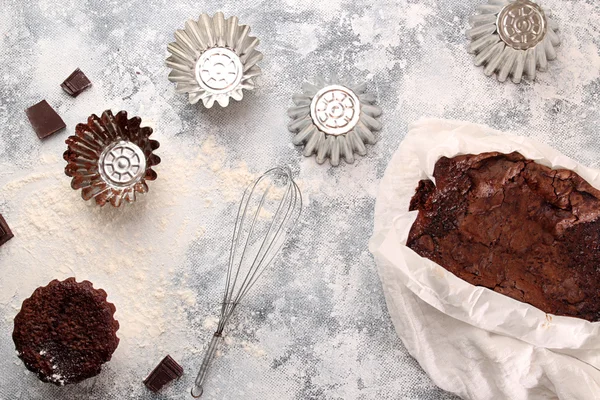 Still life with chocolate cupcake and baking utensils