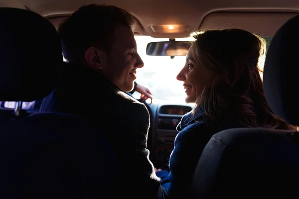 Couple looking to each other in the car