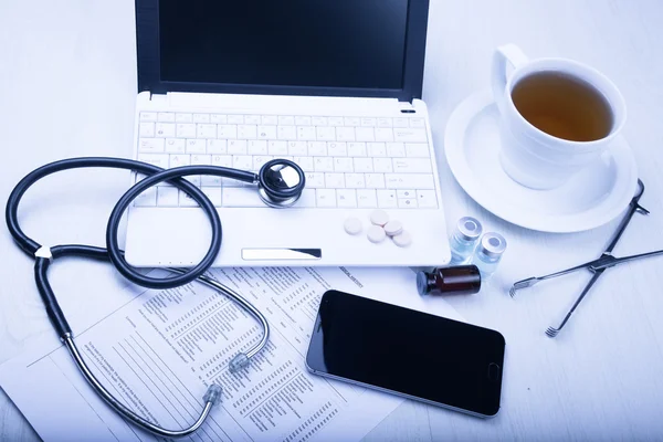 Medical devices on the table at the doctor with blue toned