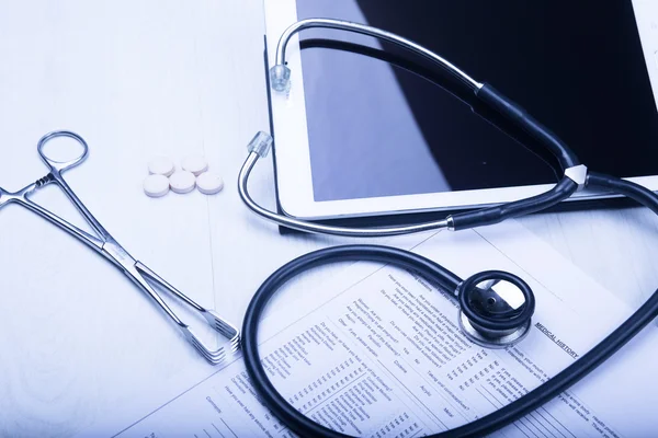 Medical devices on the table at the doctor with blue toned